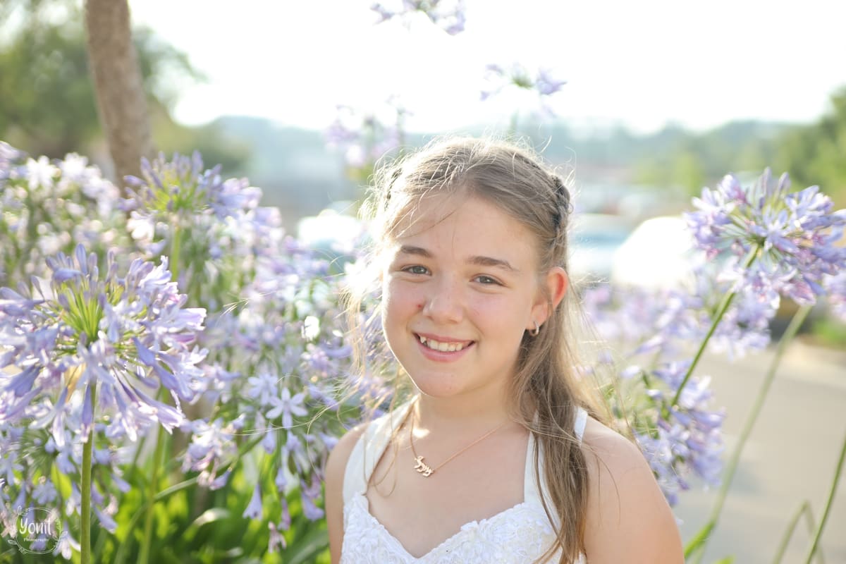 Bat mitzvah portrait near greenery